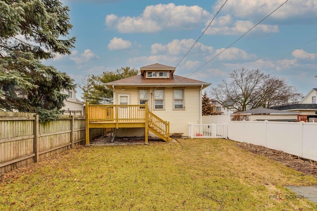 rear view of property with stairs, a lawn, a fenced backyard, and a wooden deck