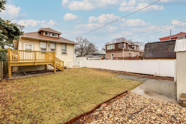 view of yard featuring a fenced backyard and a wooden deck