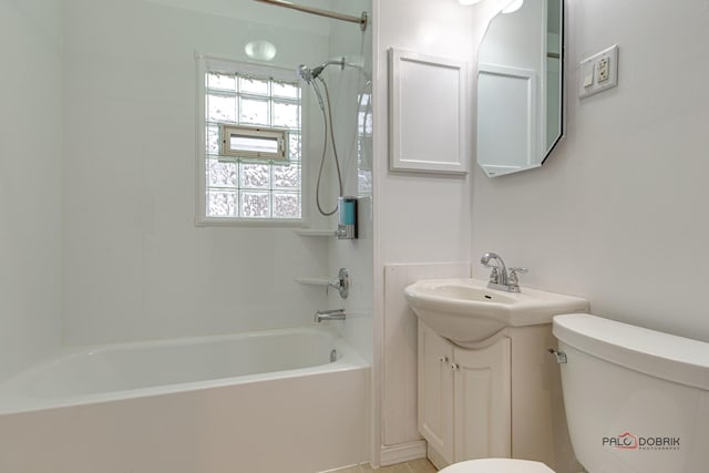 bathroom featuring  shower combination, vanity, and toilet