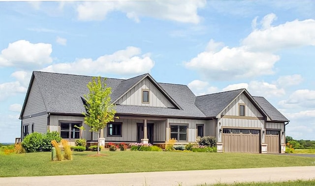 modern inspired farmhouse featuring roof with shingles, a front lawn, board and batten siding, and an attached garage