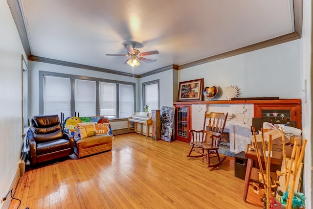 interior space featuring a baseboard heating unit, baseboards, crown molding, ceiling fan, and hardwood / wood-style floors