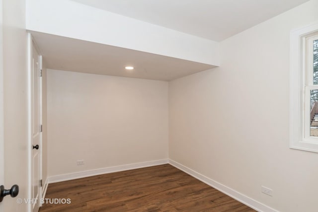 spare room featuring dark wood-style floors, recessed lighting, and baseboards