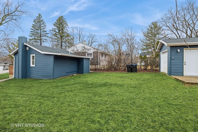 view of yard featuring an outbuilding and fence