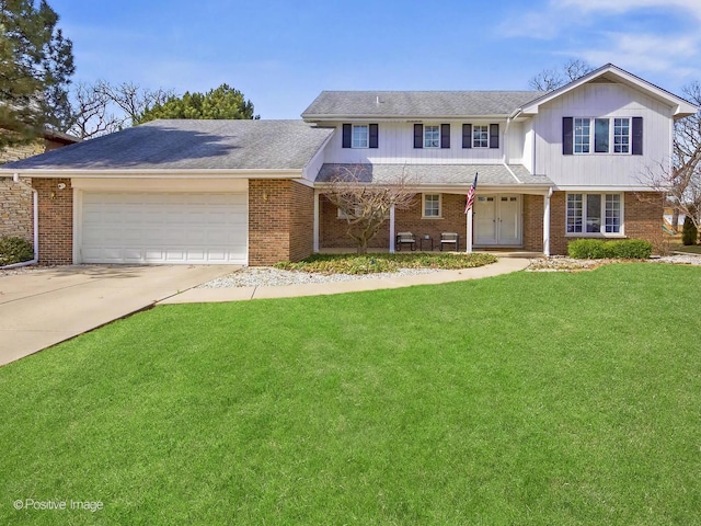 traditional-style house with a garage, brick siding, concrete driveway, and a front yard