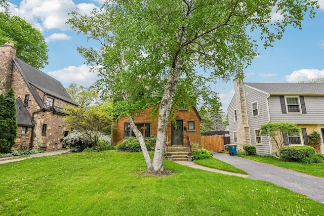 view of front of home with a front lawn and a chimney