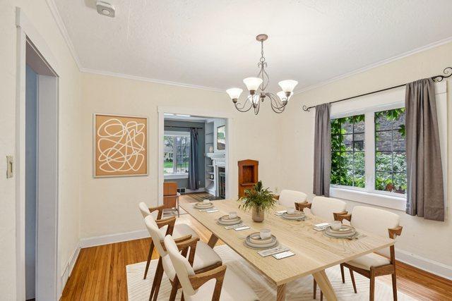 dining room featuring plenty of natural light, crown molding, baseboards, and light wood-type flooring
