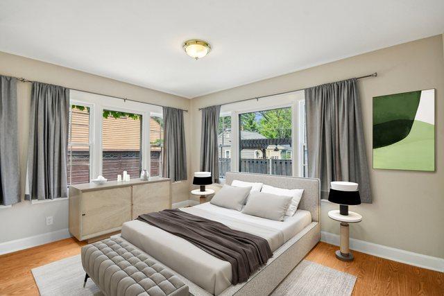 bedroom featuring baseboards and wood finished floors
