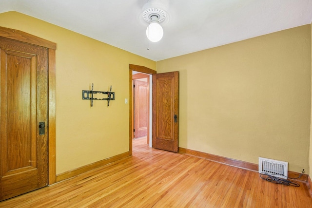 unfurnished room with light wood finished floors and baseboards
