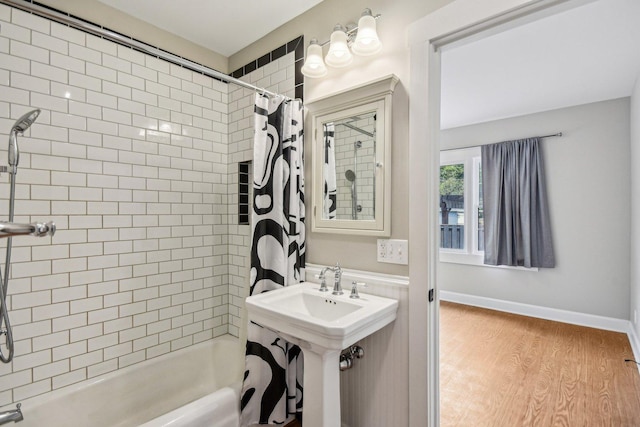bathroom with shower / bathtub combination with curtain and wood finished floors