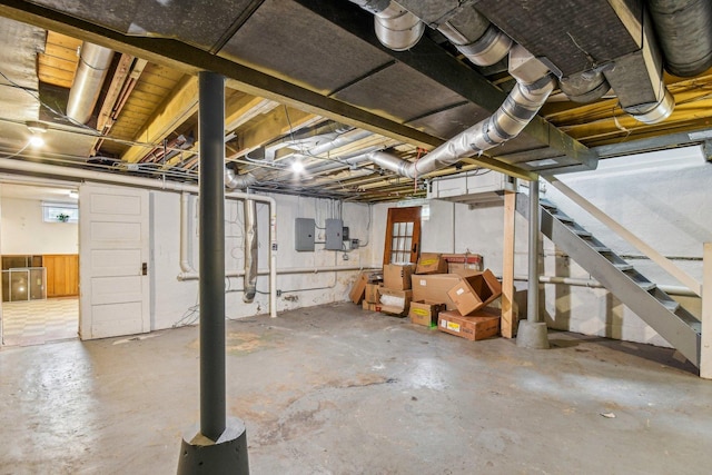 basement with electric panel and stairway