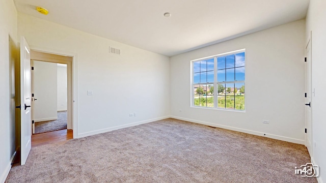 unfurnished bedroom featuring carpet flooring, visible vents, and baseboards