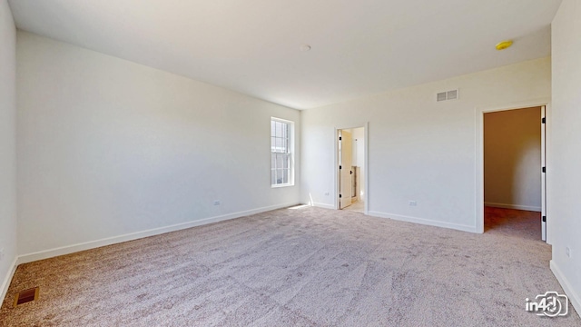 interior space with baseboards, visible vents, and carpet flooring