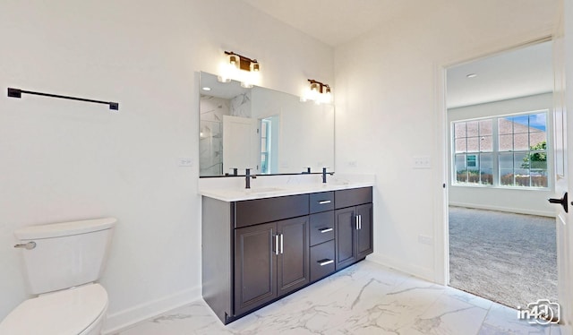 bathroom with baseboards, toilet, marble finish floor, walk in shower, and a sink