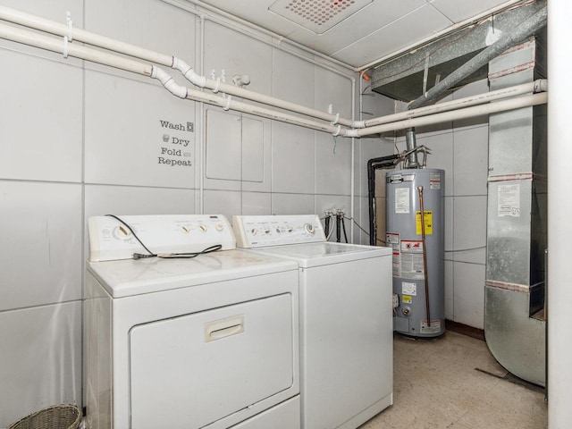 laundry room with laundry area, water heater, light floors, and independent washer and dryer