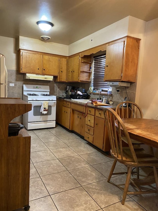 kitchen with white appliances, under cabinet range hood, decorative backsplash, and open shelves