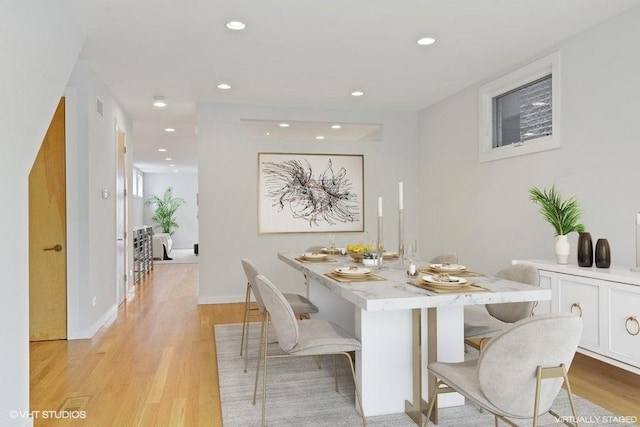 dining room with recessed lighting, light wood-style flooring, and baseboards