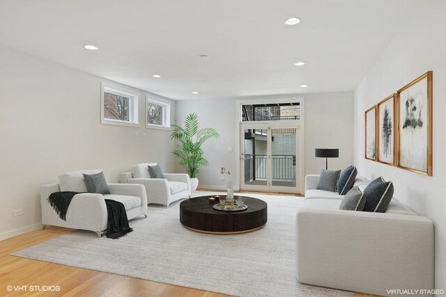 living area with recessed lighting, baseboards, and wood finished floors