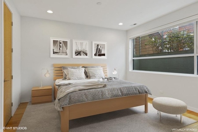 bedroom featuring baseboards, recessed lighting, visible vents, and light wood-style floors