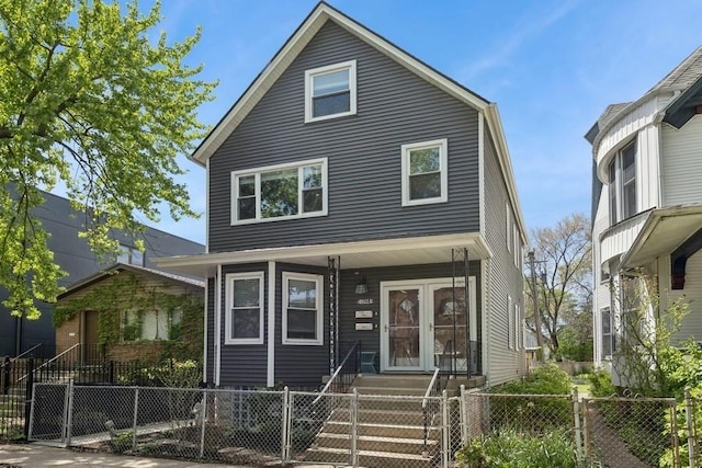 view of front of house with a fenced front yard and a gate