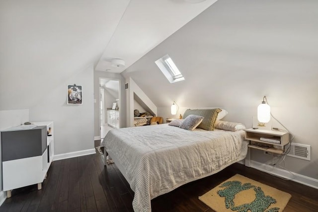 bedroom with lofted ceiling with skylight, baseboards, visible vents, and hardwood / wood-style floors