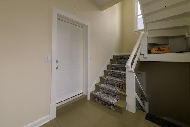 staircase featuring baseboards