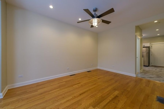 unfurnished room featuring light wood-style floors, baseboards, a ceiling fan, and recessed lighting