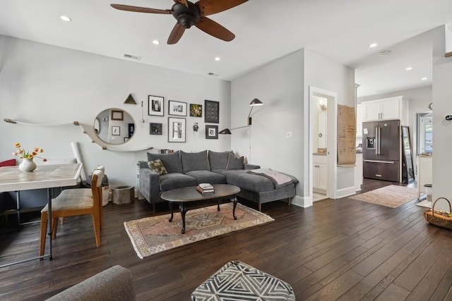 living room featuring dark wood-type flooring, recessed lighting, visible vents, and baseboards