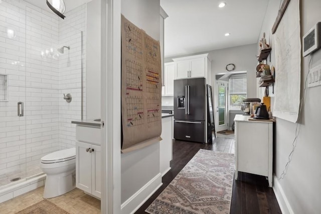 bathroom featuring recessed lighting, toilet, a shower stall, vanity, and wood finished floors