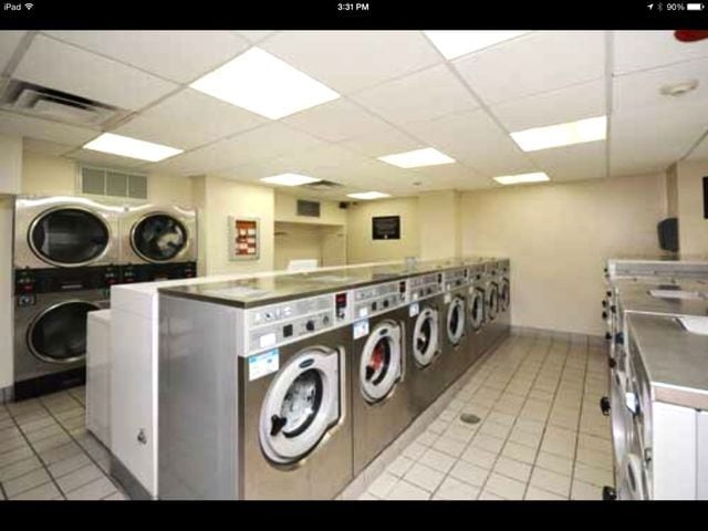 community laundry room with light tile patterned floors, separate washer and dryer, stacked washer / dryer, and visible vents