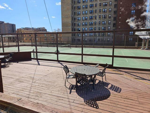 view of tennis court featuring fence