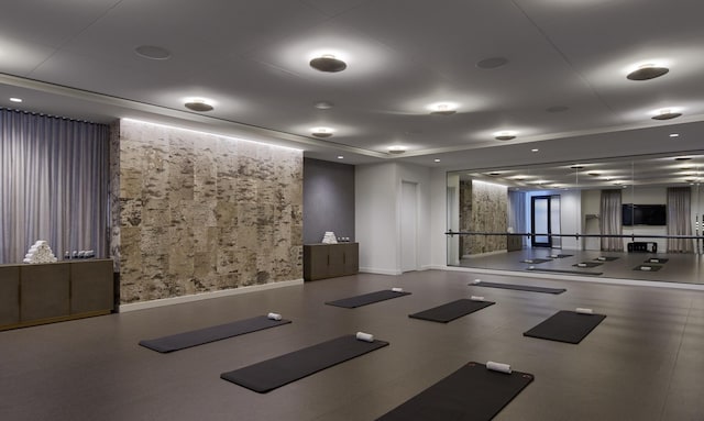 exercise room featuring baseboards and wallpapered walls