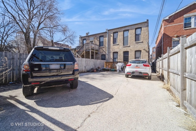 view of parking featuring fence