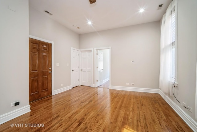 interior space featuring baseboards, visible vents, and light wood finished floors