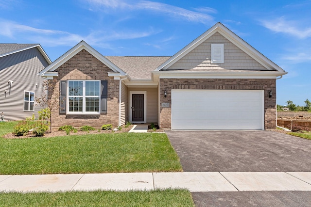 view of front of property with driveway, an attached garage, a front lawn, and brick siding