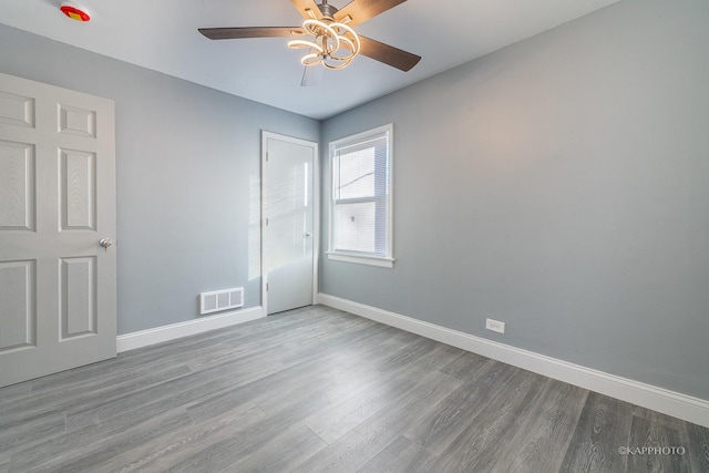 unfurnished bedroom with baseboards, visible vents, ceiling fan, and wood finished floors