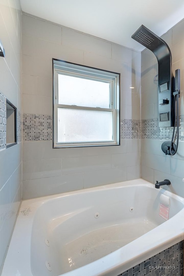 bathroom featuring a tub with jets and walk in shower