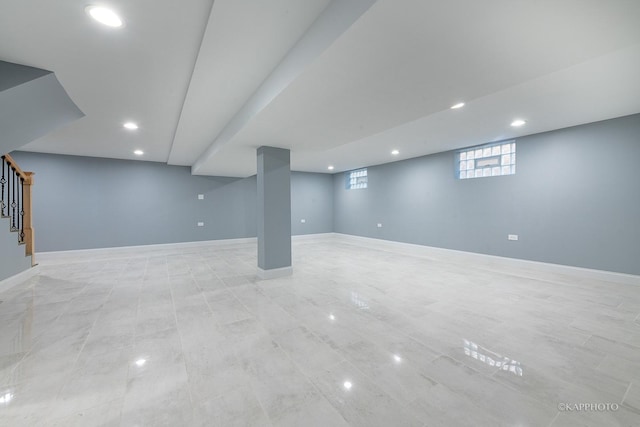 basement featuring recessed lighting, stairway, and baseboards