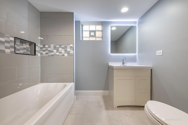 bathroom with baseboards, vanity, and toilet