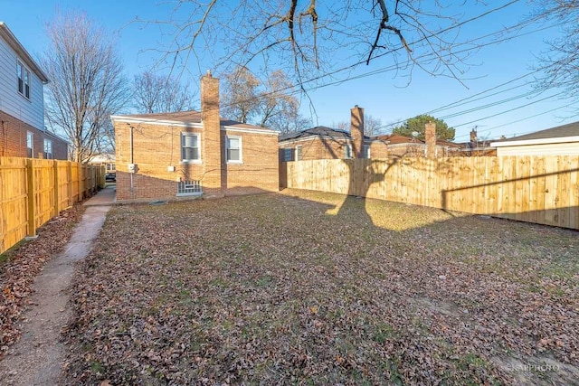 view of yard with a fenced backyard