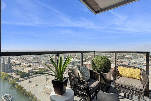 balcony featuring outdoor lounge area and a water view