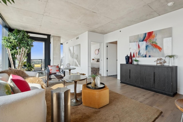 living room with expansive windows and wood finished floors