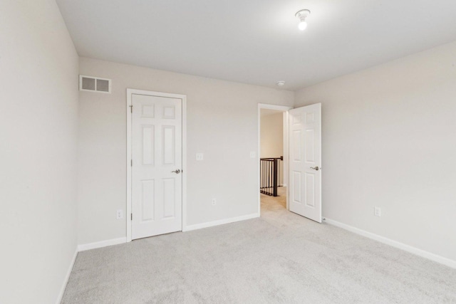 unfurnished bedroom featuring carpet floors, baseboards, and visible vents