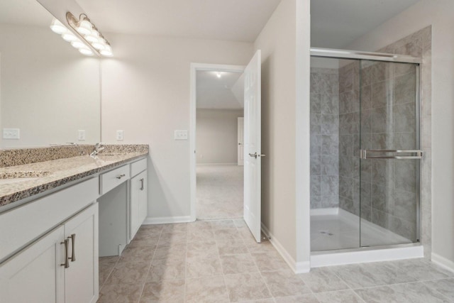 full bath with baseboards, a shower stall, vanity, and tile patterned floors