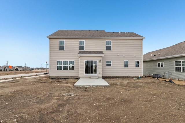 rear view of house with a patio area and central AC unit