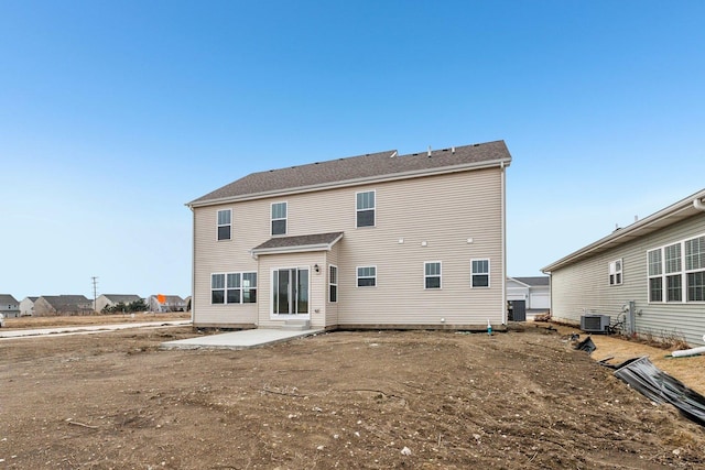 rear view of house with a patio and central air condition unit