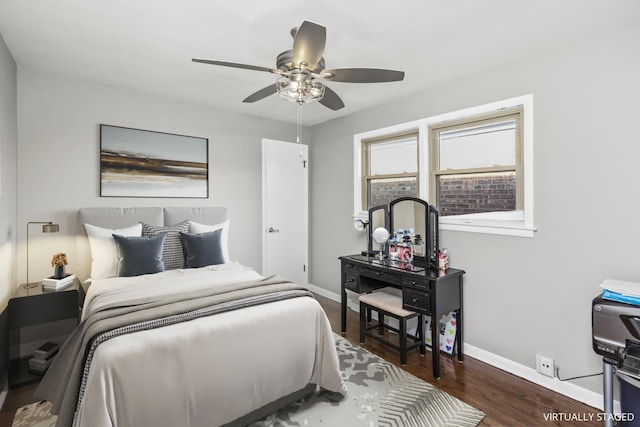 bedroom with wood finished floors, a ceiling fan, and baseboards