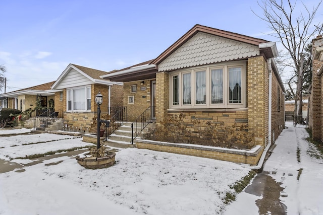 bungalow-style house with stone siding and brick siding