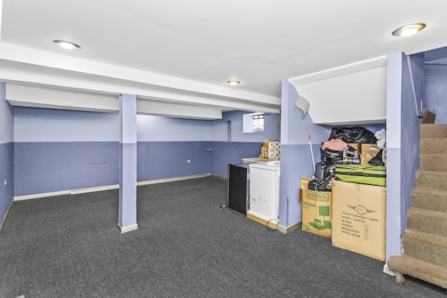 basement with carpet floors, baseboards, and stairway