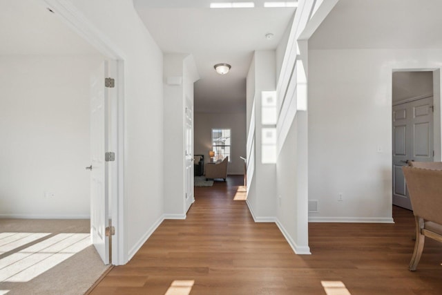 entryway featuring baseboards and wood finished floors