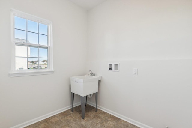 laundry room featuring laundry area, hookup for a washing machine, and baseboards